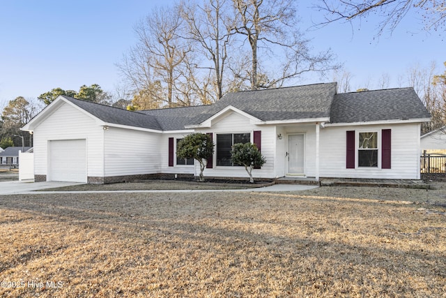 ranch-style house with a garage and a front lawn