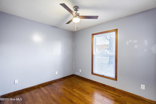 empty room with hardwood / wood-style floors, a textured ceiling, and ceiling fan