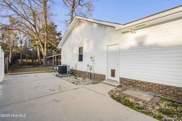 exterior space with cooling unit and a patio area