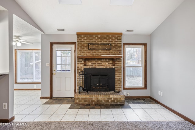 unfurnished living room featuring vaulted ceiling, light tile patterned floors, and a textured ceiling