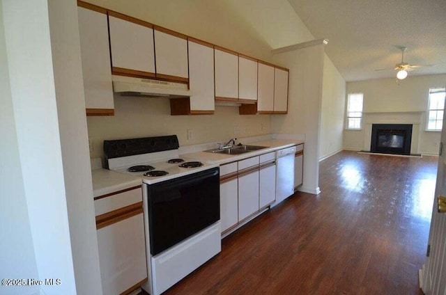 kitchen with sink, white appliances, a textured ceiling, and white cabinets