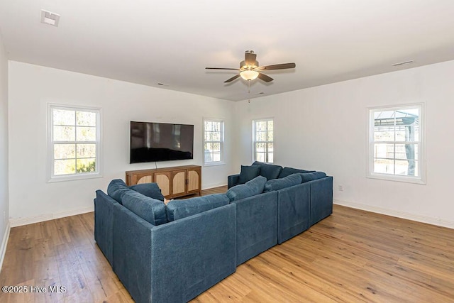 living room featuring wood-type flooring and ceiling fan