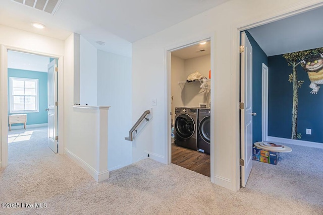 washroom featuring separate washer and dryer and light carpet