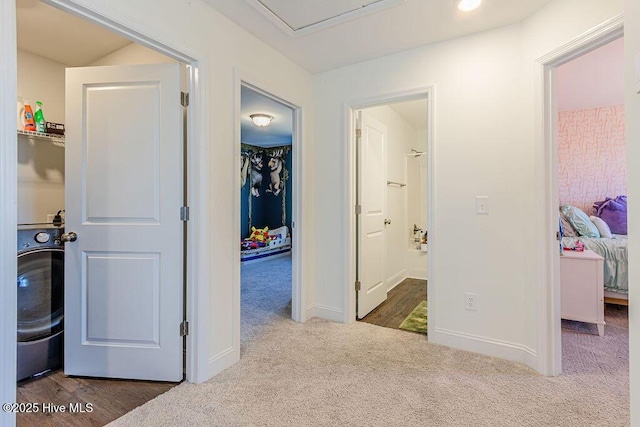 hall with washer / dryer and carpet