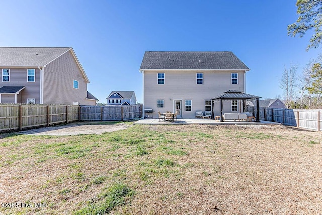 rear view of house with a gazebo, a yard, and a patio