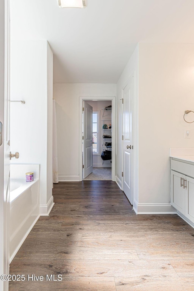 hallway with hardwood / wood-style floors