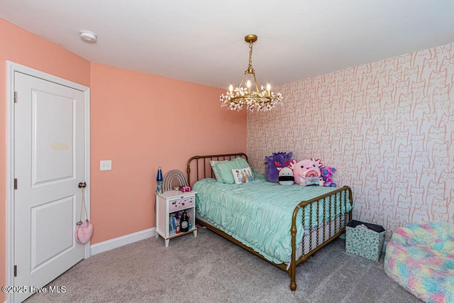 carpeted bedroom featuring an inviting chandelier