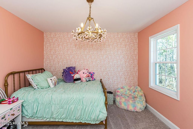 bedroom with a notable chandelier and carpet flooring