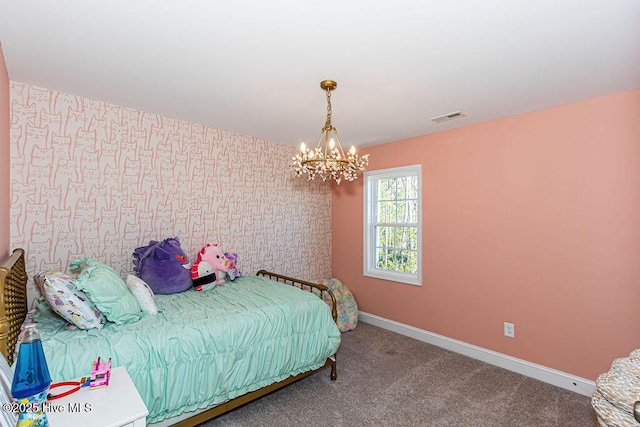 bedroom featuring carpet and a notable chandelier