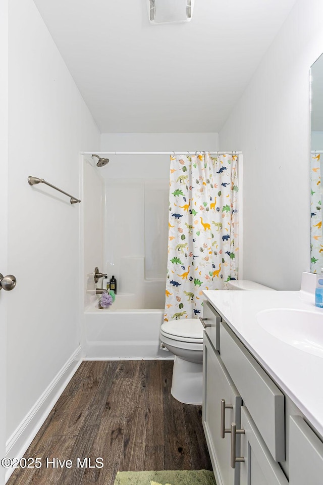 full bathroom featuring shower / bathtub combination with curtain, vanity, wood-type flooring, and toilet