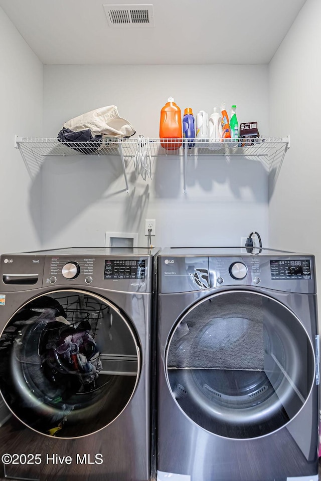 laundry room with washing machine and dryer