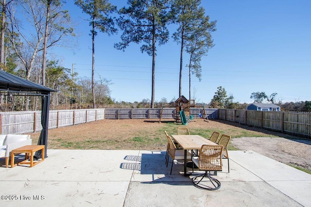 view of patio with a playground and a gazebo