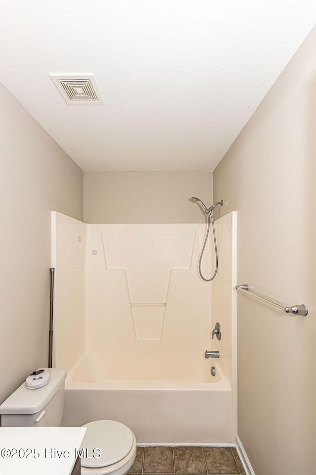 bathroom featuring shower / bathing tub combination, tile patterned floors, and toilet