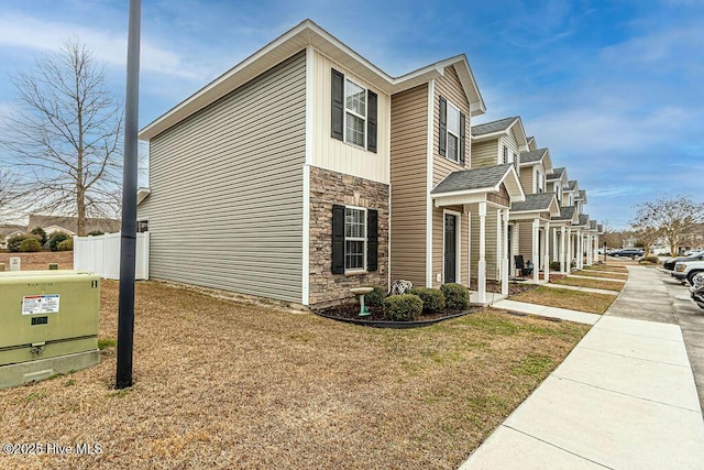 view of side of property featuring a lawn