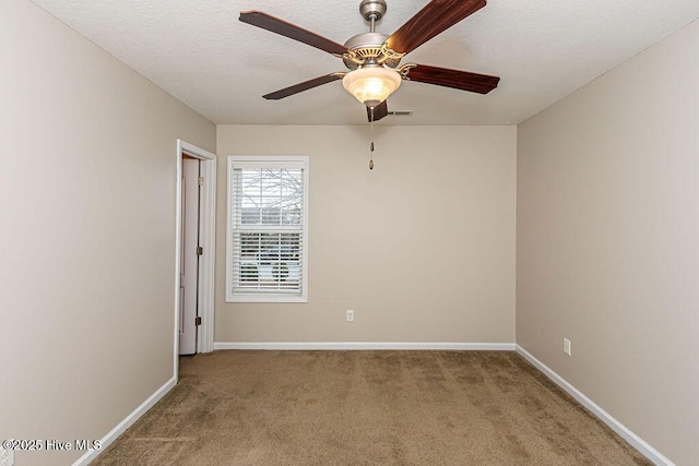 spare room with ceiling fan and carpet flooring