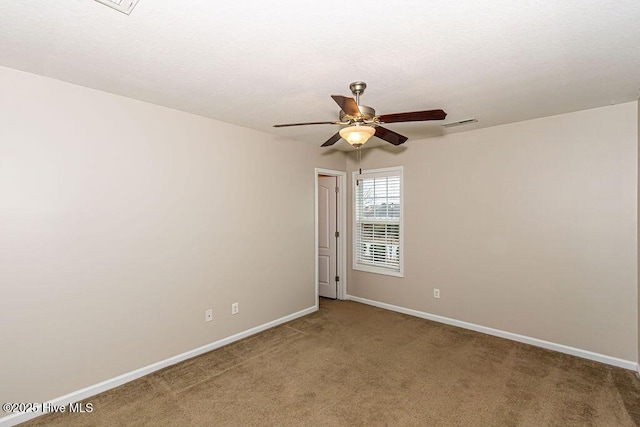 spare room with carpet floors and ceiling fan