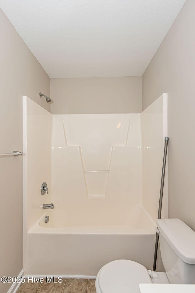 bathroom with tile patterned flooring, toilet, and shower / bath combination