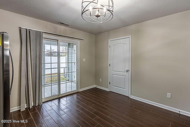 interior space featuring an inviting chandelier and a textured ceiling