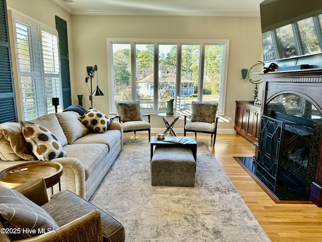 living room with plenty of natural light, a high end fireplace, and hardwood / wood-style flooring