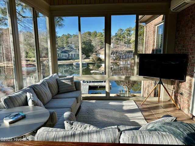 sunroom / solarium featuring an AC wall unit and plenty of natural light