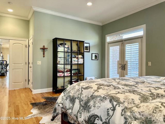 bedroom with light wood-type flooring, access to exterior, crown molding, and french doors