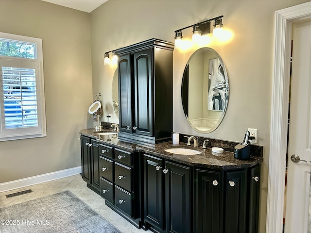 bathroom featuring a healthy amount of sunlight, vanity, and tile patterned floors