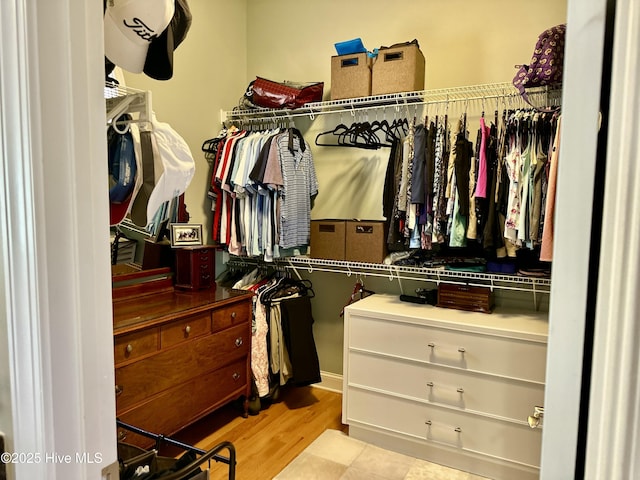 walk in closet featuring light hardwood / wood-style flooring