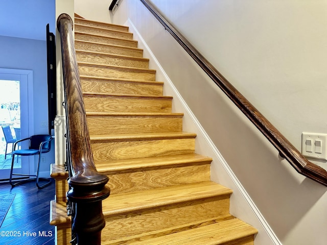 staircase featuring hardwood / wood-style flooring