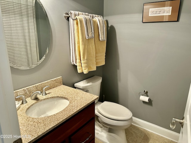 bathroom with tile patterned floors, vanity, and toilet