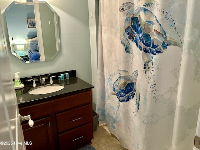 bathroom with a shower with shower curtain, tile patterned floors, and vanity