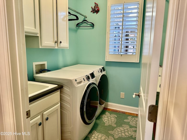 laundry area with cabinets and washing machine and clothes dryer