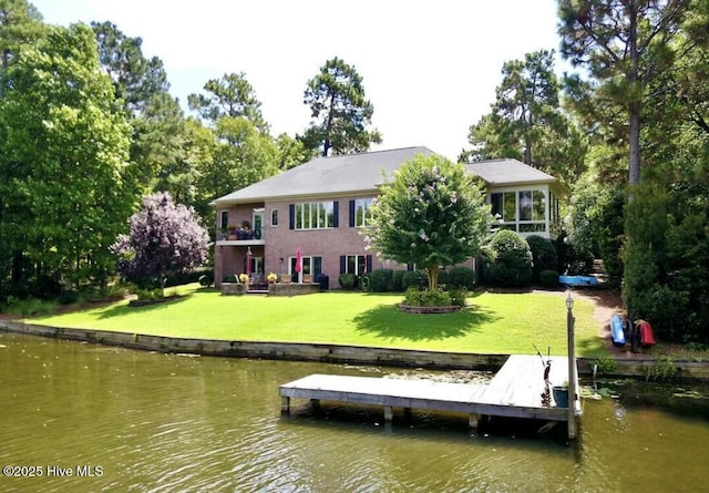 rear view of property featuring a yard and a water view