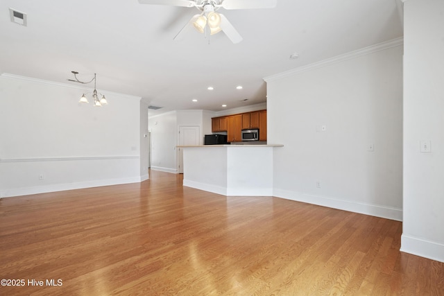 7195 Bonaventure St SW Apt 104, Ocean Isle Beach, NC 28469 - unfurnished living room featuring crown molding, a chandelier, ceiling fan, recessed lighting, and baseboards