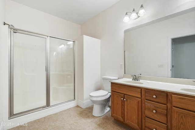 7195 Bonaventure St SW Apt 104, Ocean Isle Beach, NC 28469 - bathroom with a shower stall, toilet, tile patterned floors, and double vanity