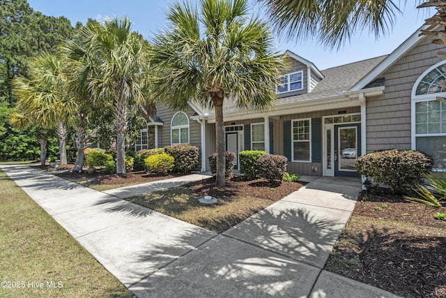 7195 Bonaventure St SW Apt 104, Ocean Isle Beach, NC 28469 - view of front of property featuring roof with shingles and a porch