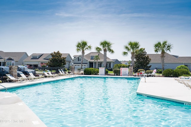 7195 Bonaventure St SW Apt 104, Ocean Isle Beach, NC 28469 - community pool featuring fence, a residential view, and a patio