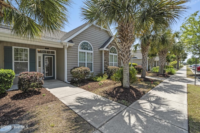 7195 Bonaventure St SW Apt 104, Ocean Isle Beach, NC 28469 - view of front facade with roof with shingles