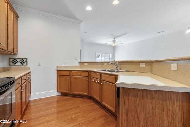 7195 Bonaventure St SW Apt 104, Ocean Isle Beach, NC 28469 - kitchen with a sink, crown molding, stainless steel range with electric cooktop, light wood-style flooring, and brown cabinets