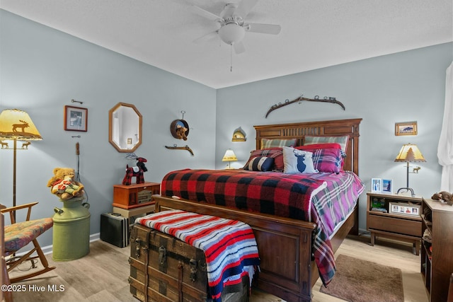 bedroom with ceiling fan and light hardwood / wood-style flooring