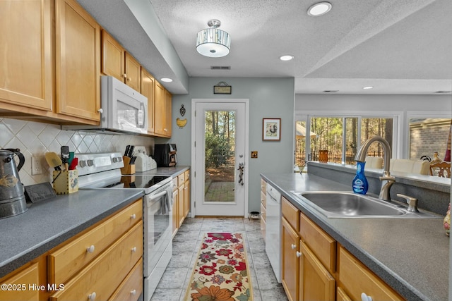 kitchen with decorative backsplash, sink, white appliances, and a textured ceiling