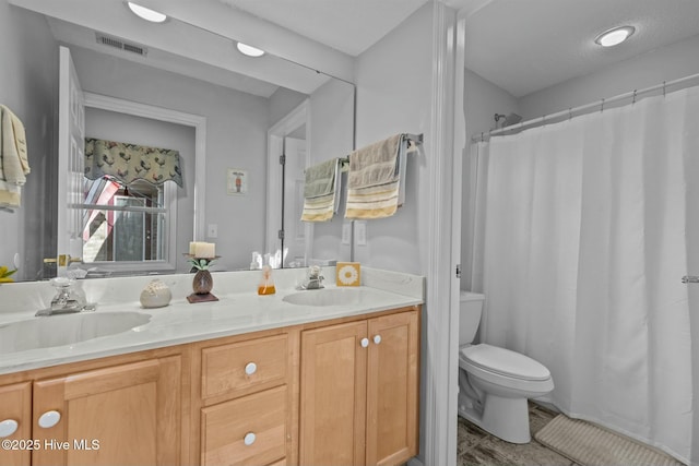 bathroom with toilet, hardwood / wood-style floors, vanity, and curtained shower