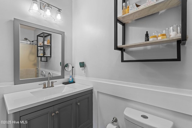 bathroom featuring vanity and toilet