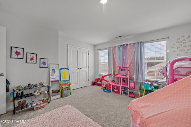 recreation room featuring plenty of natural light, visible vents, and carpet floors