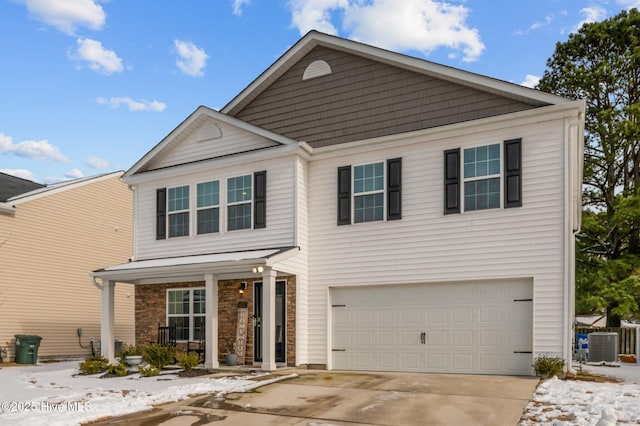 traditional-style house featuring covered porch, cooling unit, driveway, and an attached garage