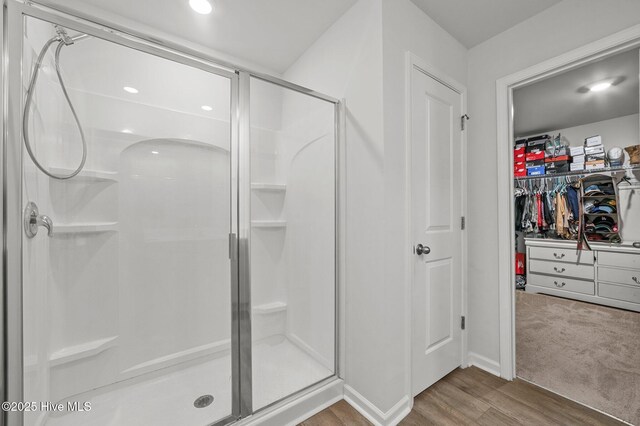 bathroom with hardwood / wood-style flooring and toilet