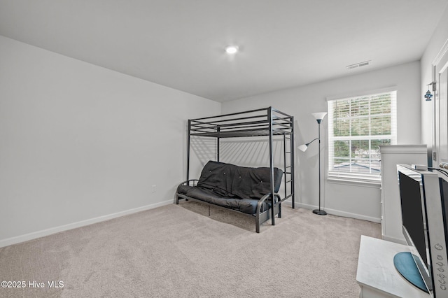 carpeted bedroom featuring visible vents and baseboards