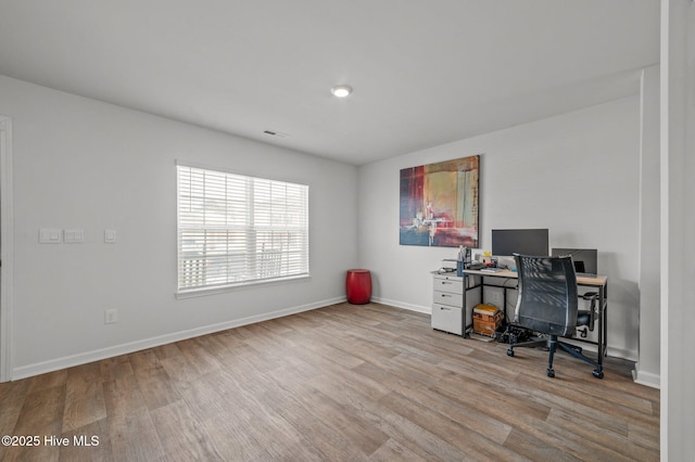 home office with baseboards and wood finished floors