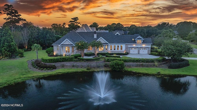 exterior space with a water view and a yard