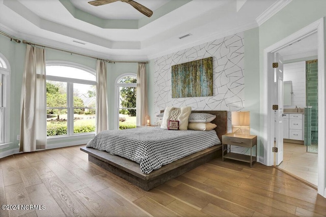 bedroom with crown molding, visible vents, and hardwood / wood-style flooring