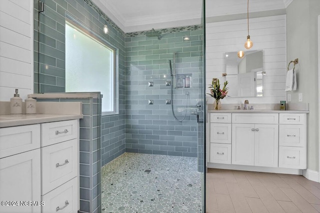 bathroom featuring crown molding, a stall shower, and vanity
